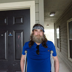 Permanent Supportive Housing Resident in front of their front door