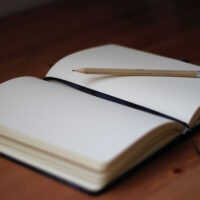 A sharp pencil perched on a journal